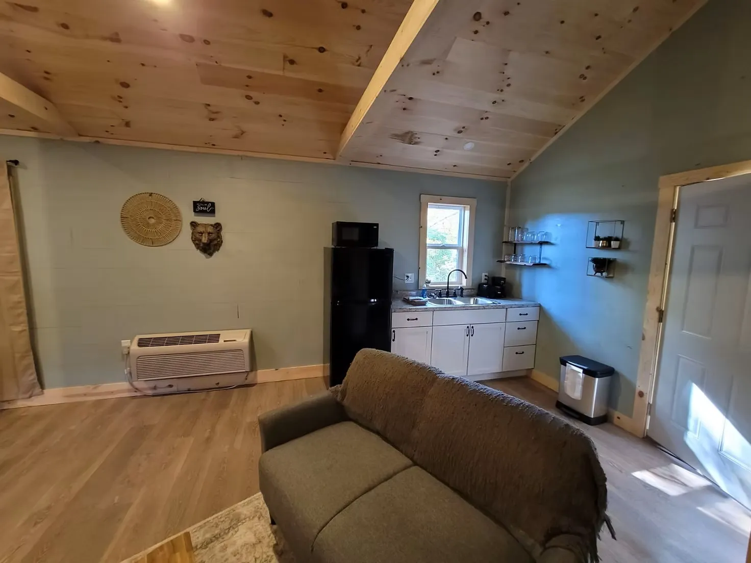 Bedroom with queen bed and warm glow from the double-sided fireplace at Butterfly Ridge cabin