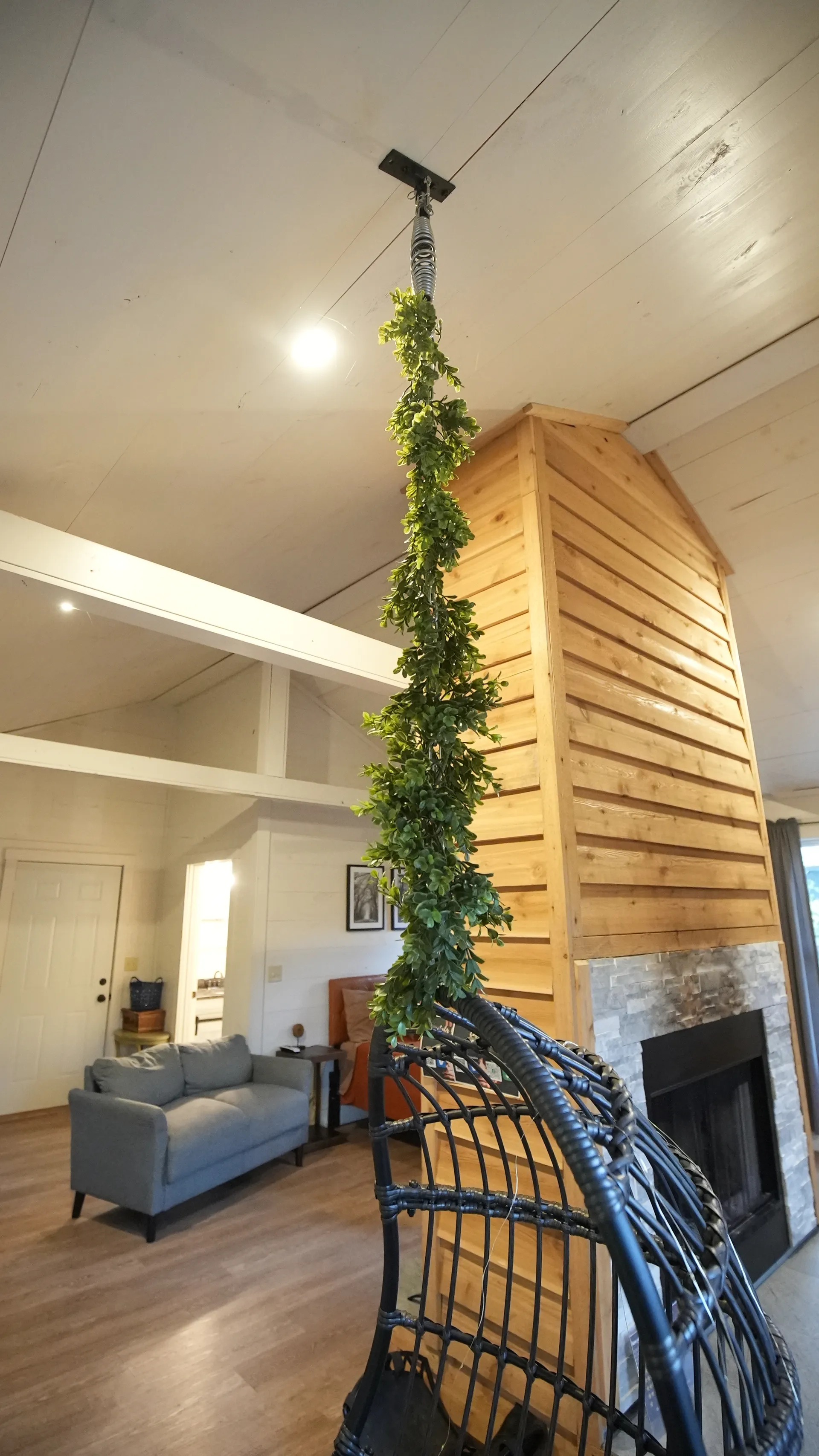 View of the bedroom area from the living room through the fireplace divider at Butterfly Ridge cabin