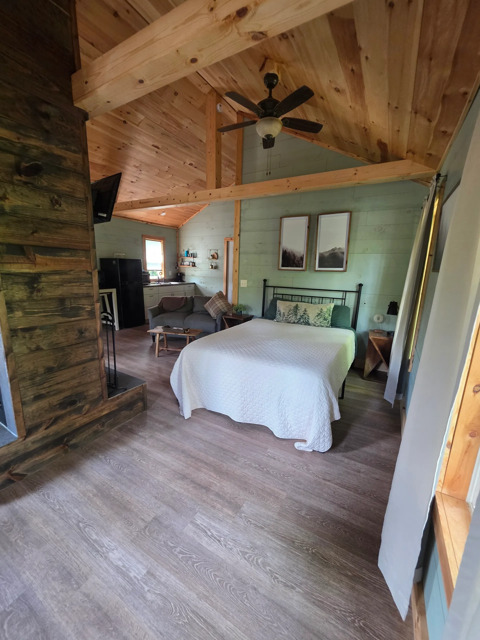 Bedside nightstand with clothing rack and shiplap walls at Butterfly Ridge cabin