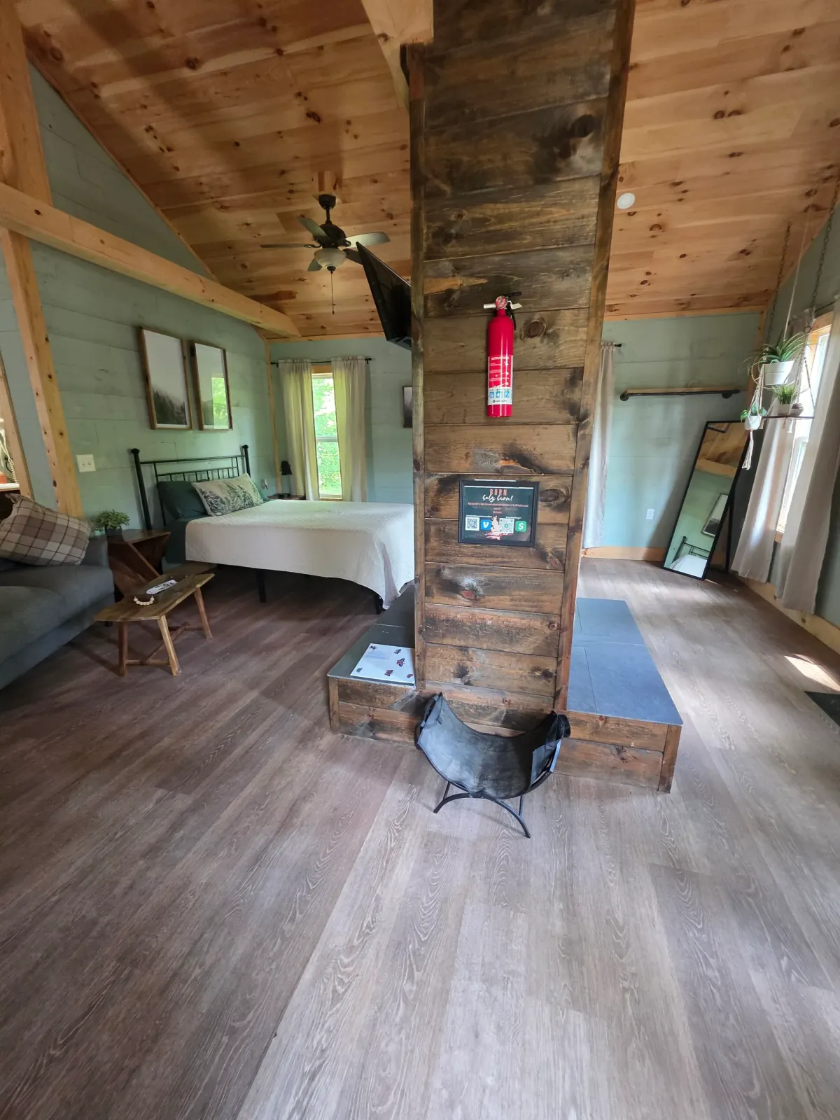Back deck with American flag, bistro table, and hot tub at Butterfly Ridge cabin