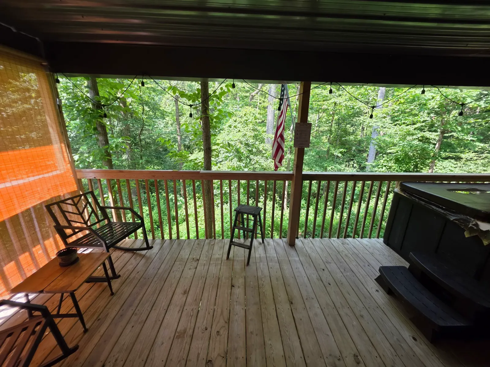 Back of Butterfly Ridge cabin showing the raised deck and stairs among the trees