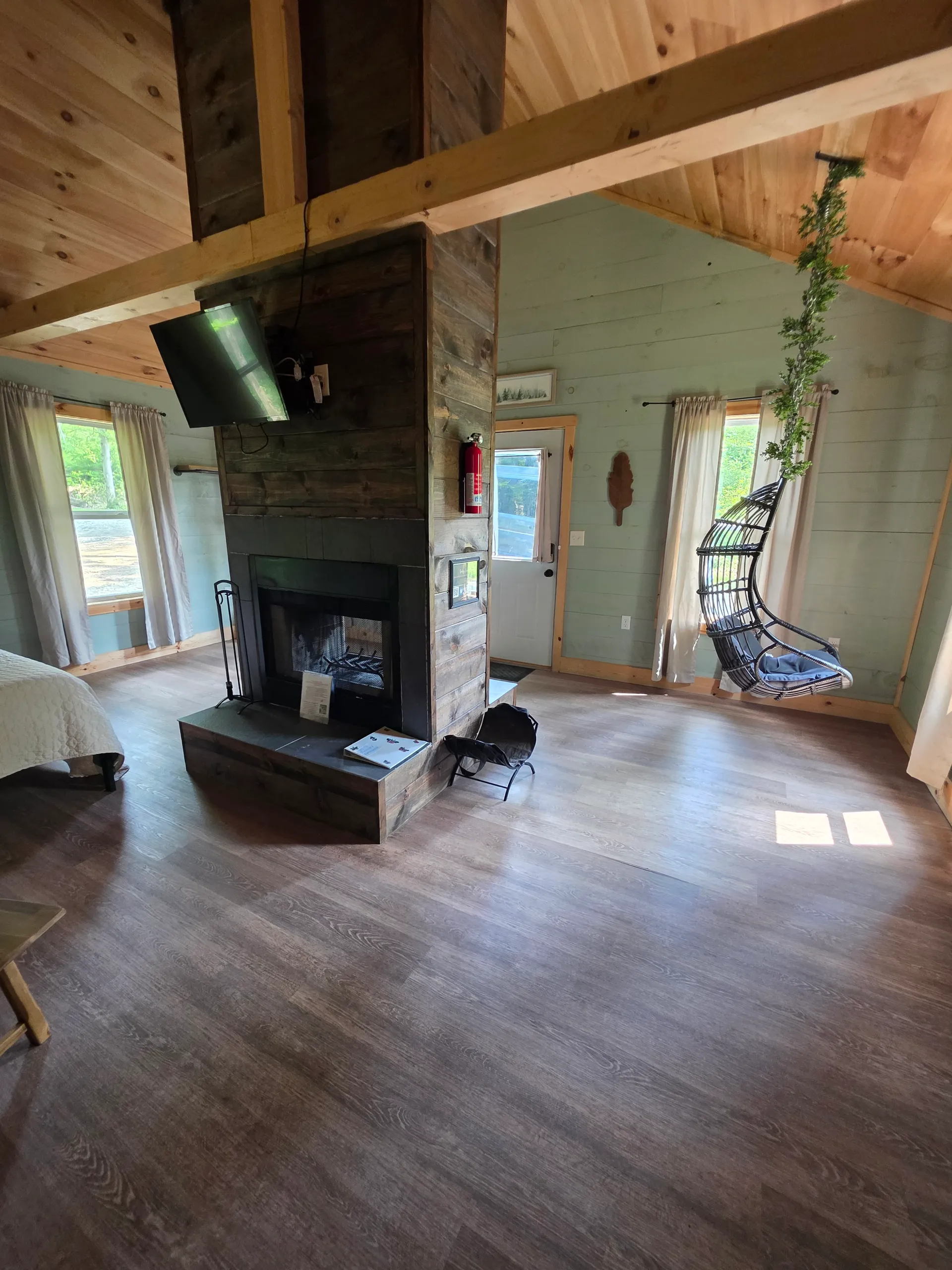 Full kitchenette with white cabinets, black appliances, and floating shelves at Butterfly Ridge cabin