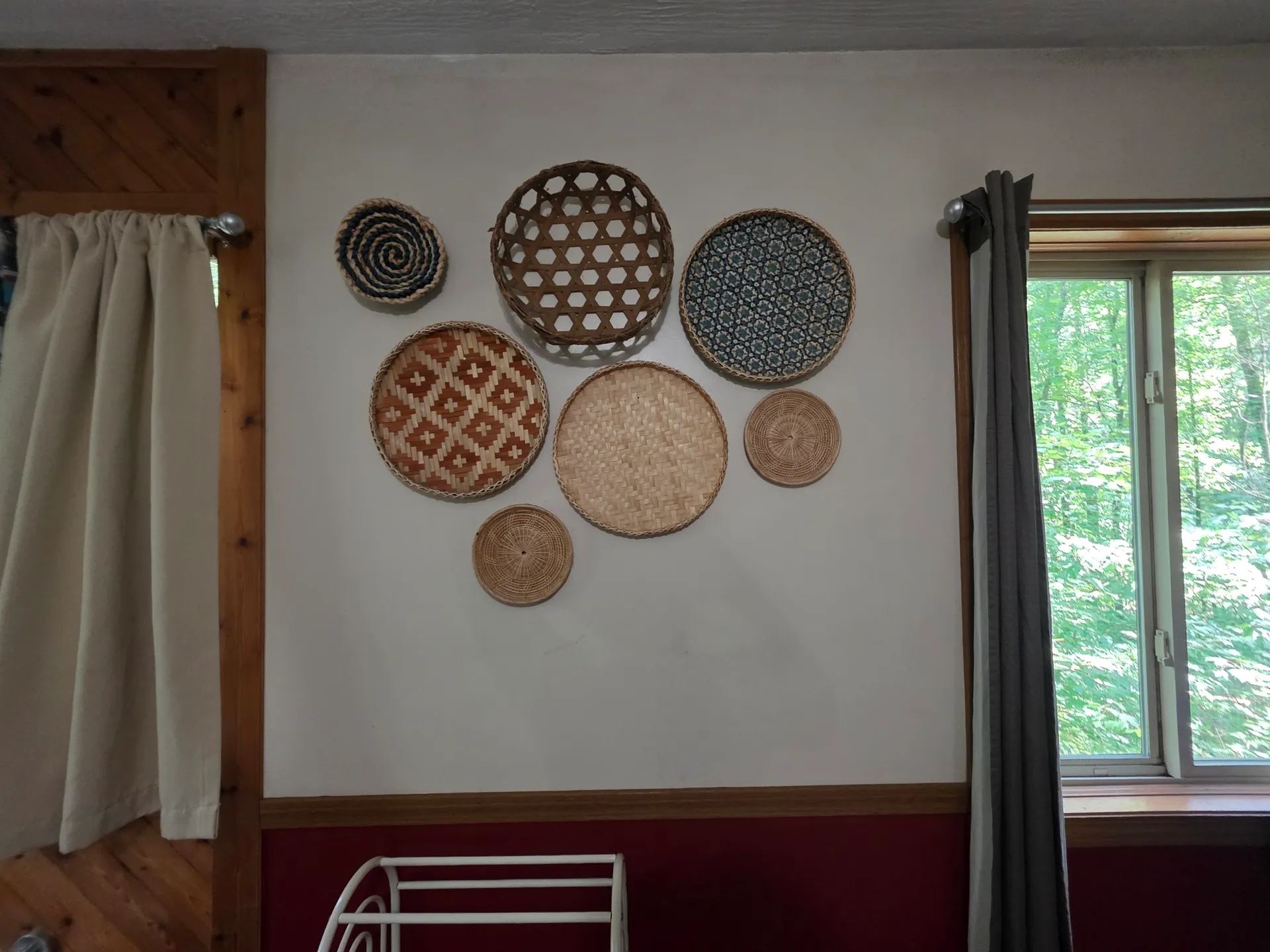 Decorative woven basket wall art collection with forest view window at Cherokee Way cabin