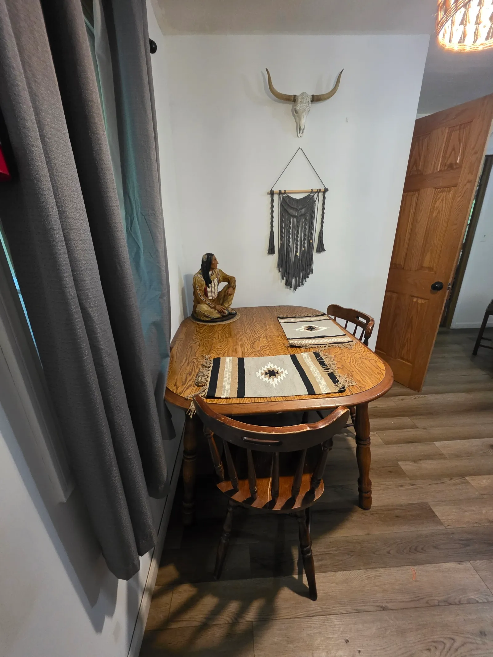 Living room with rocking chair, decorative arrow, and Southwestern styled furnishings at Cherokee Way cabin