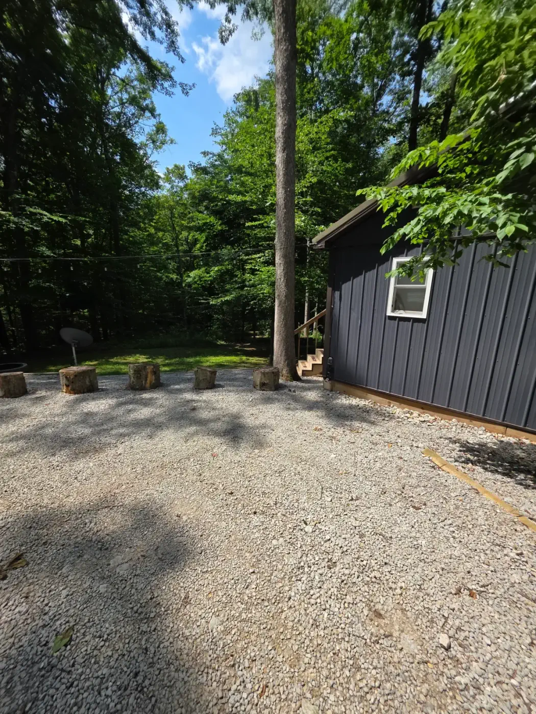 Side view of Dogwood Run cabin showing the raised deck and stairs