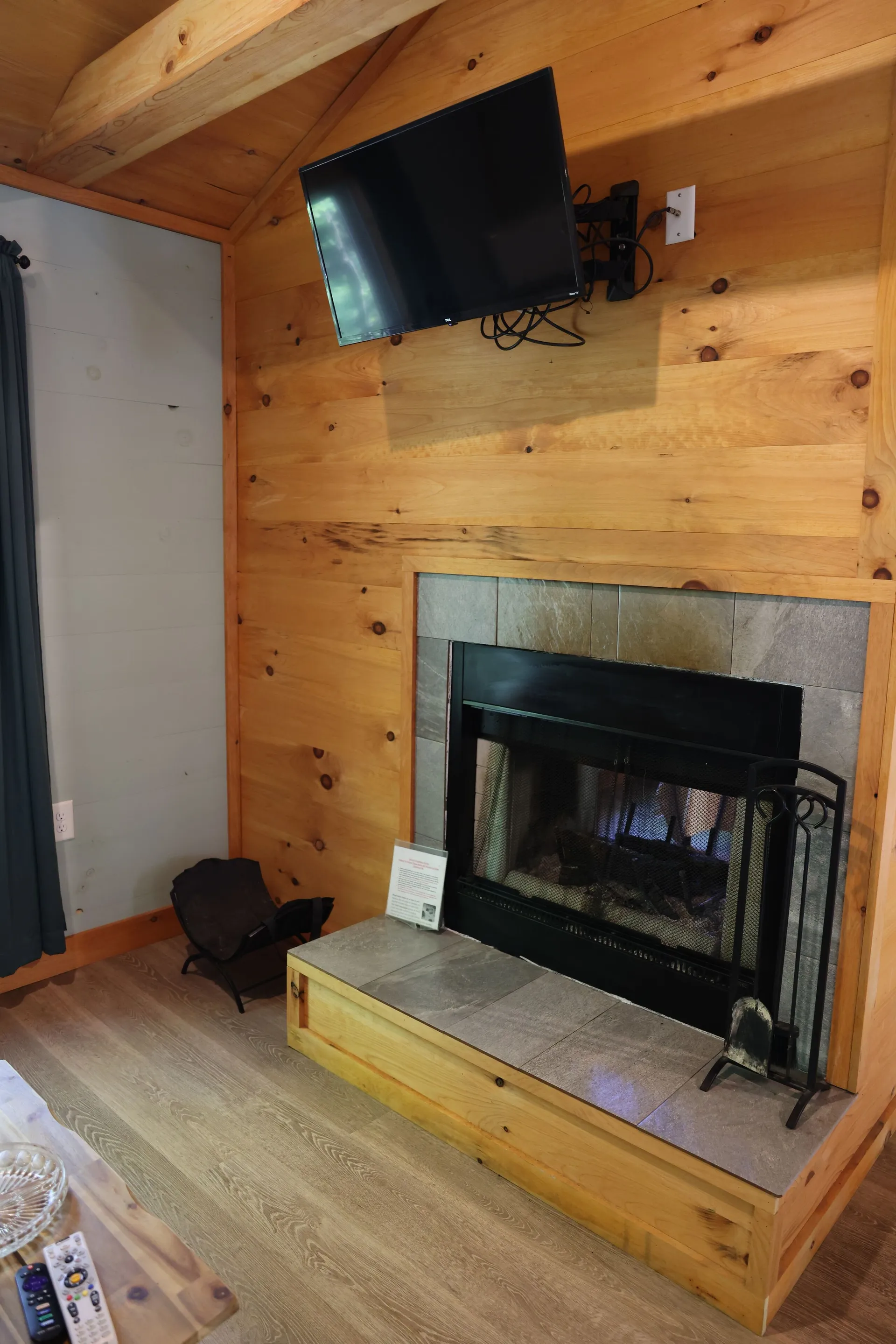 Wood-paneled fireplace wall with TV mount and slate hearth at Dogwood Run cabin