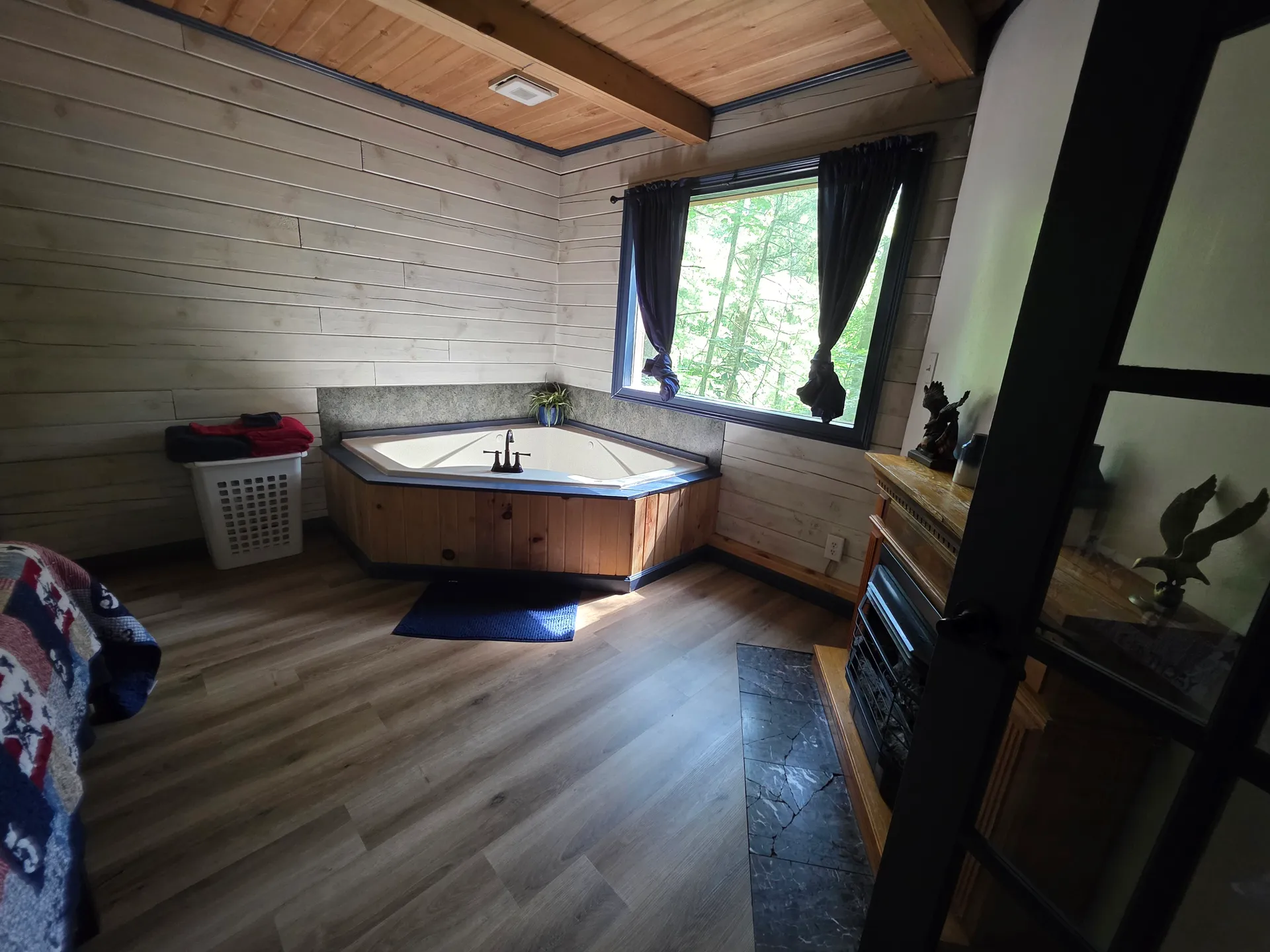 Private indoor jacuzzi tub with forest view window in Eagles Nest cabin master suite