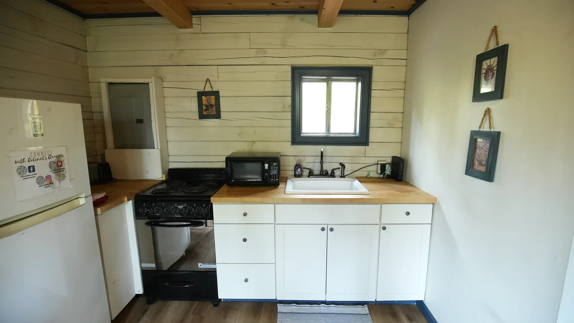 Eagles Nest cabin fully equipped kitchen with stove, microwave, sink, and butcher block countertops