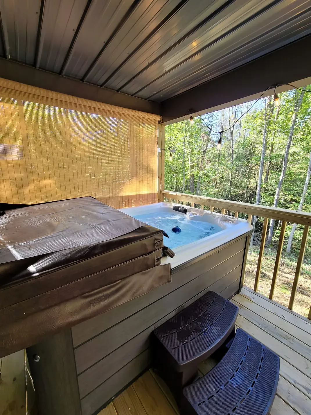 Bedroom area with queen bed, tufted headboard, and framed artwork at Firefly cabin