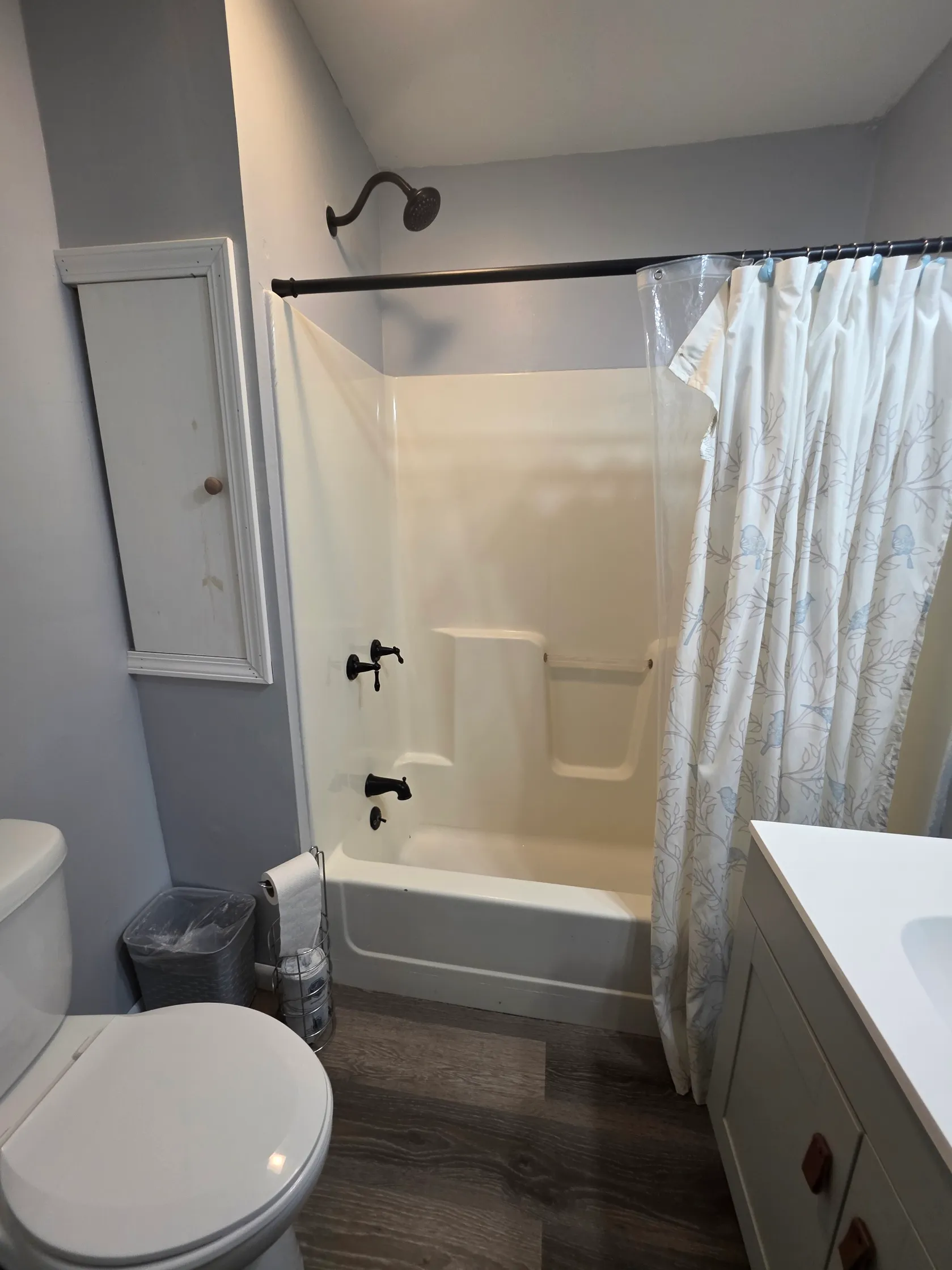 Bathroom with soaking tub, shower curtain, and updated fixtures at Getaway House cabin